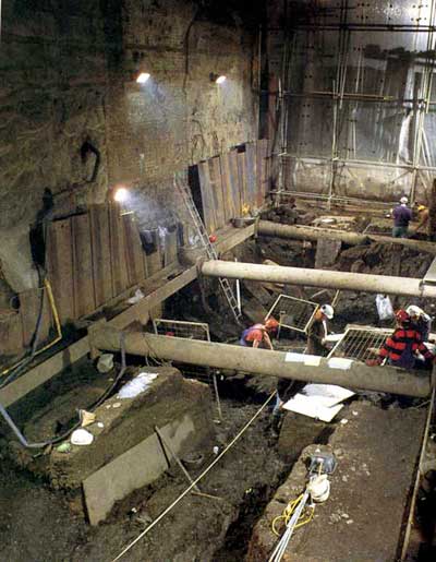 Caption: ‘The waterfront timbers were removed after detailed recording both on plans and by elevation drawings. Slices of the timbers were taken to provide dating information through the science of dendrochronology (tree-ring dating)